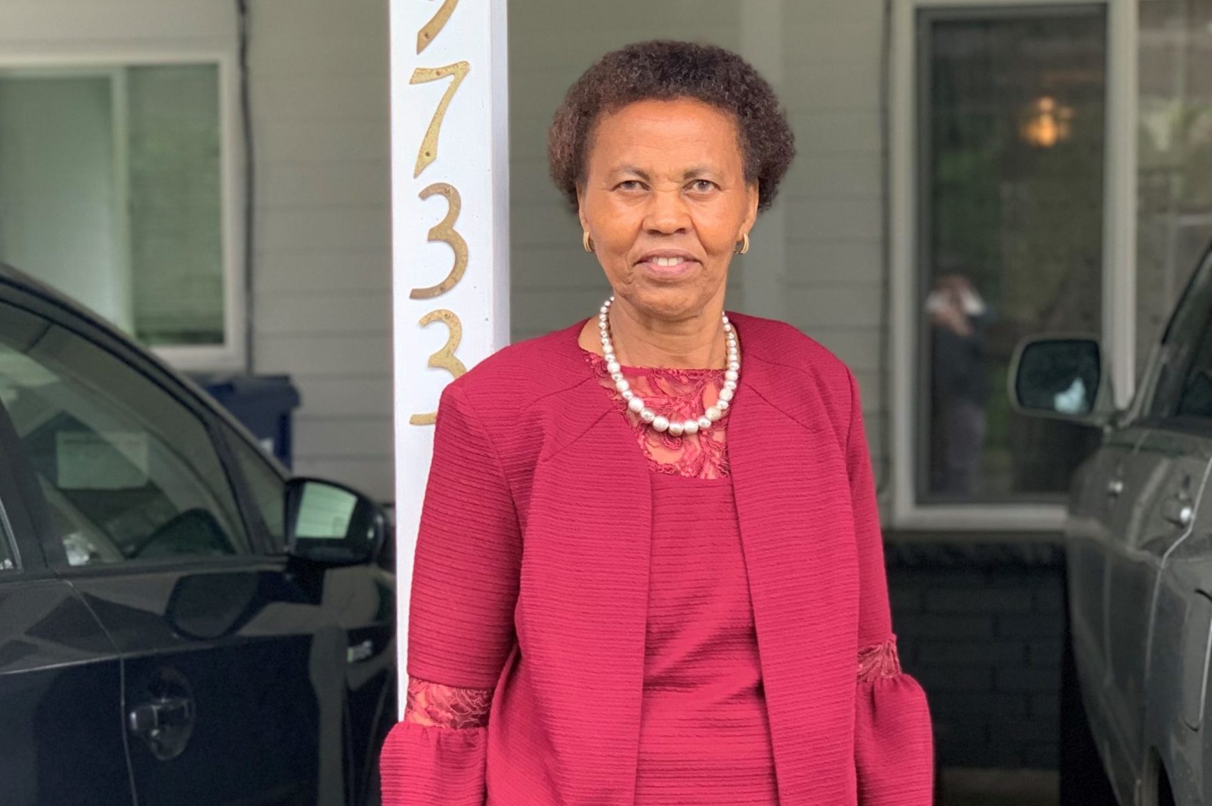 Catherine Kamau in front of her storefront address.